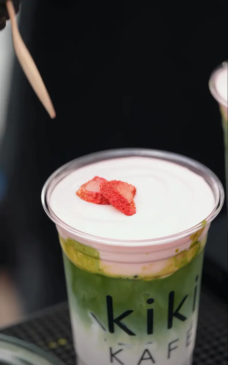 Strawberry cream matcha in a Kiki Kafé cup