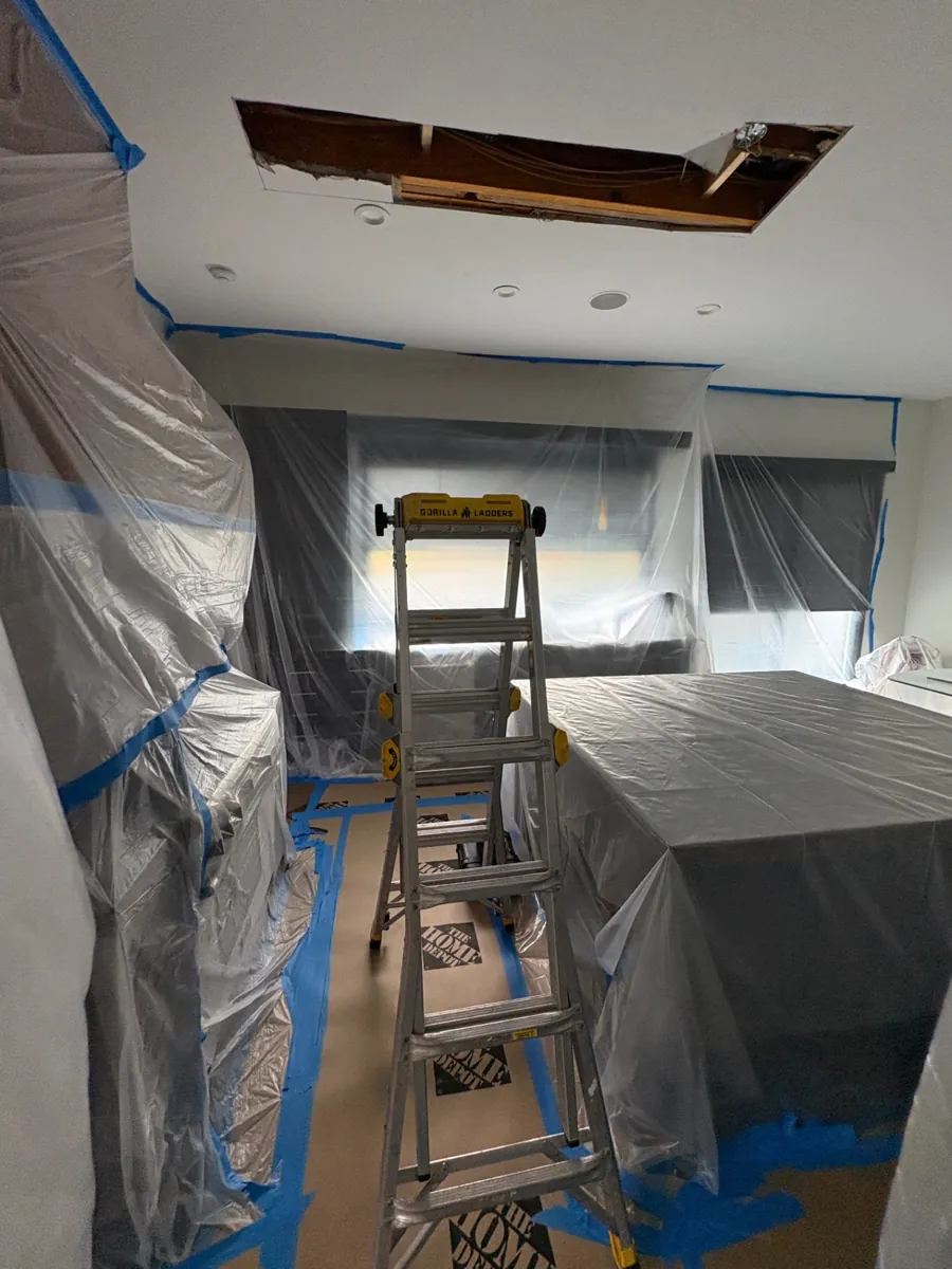 Plastic containment around a ceiling repair in a Bloomfield Hills home